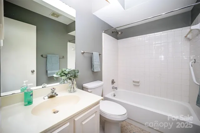a bathroom with a sink mirror toilet and bathtub