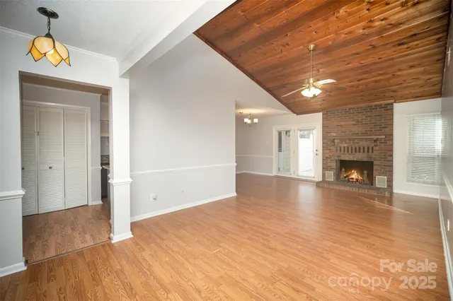 a view of a livingroom with wooden floor and a ceiling fan