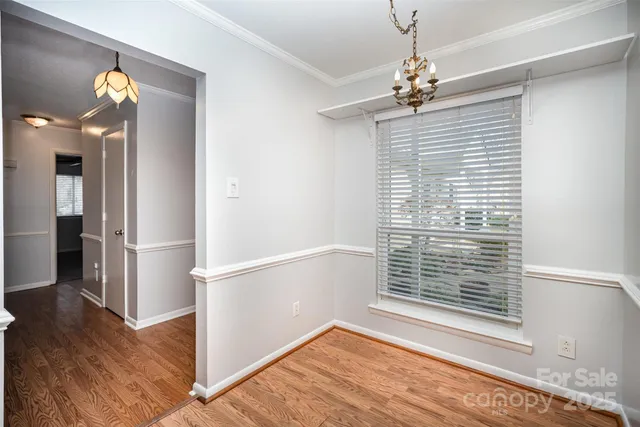 a view of a livingroom with wooden floor and a ceiling fan