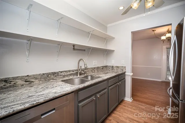 a kitchen with a sink stove and refrigerator