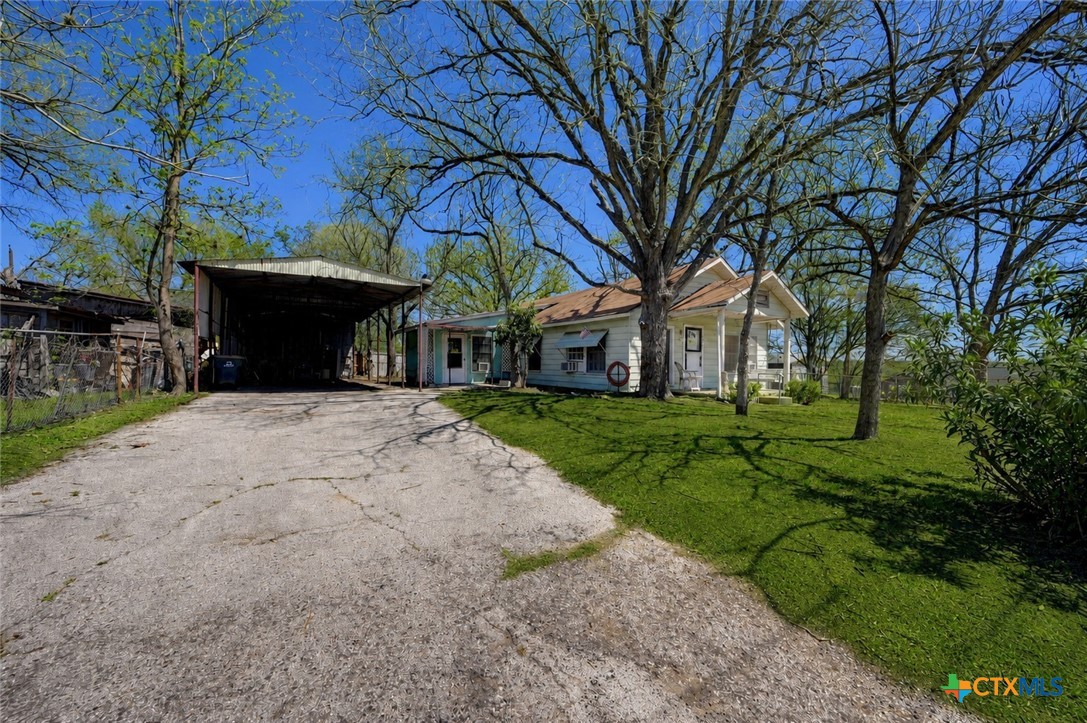 1631 East Fannin Street Luling, TX 78648 - Photo 25 of 27 a front view of a house with a yard and shrubs