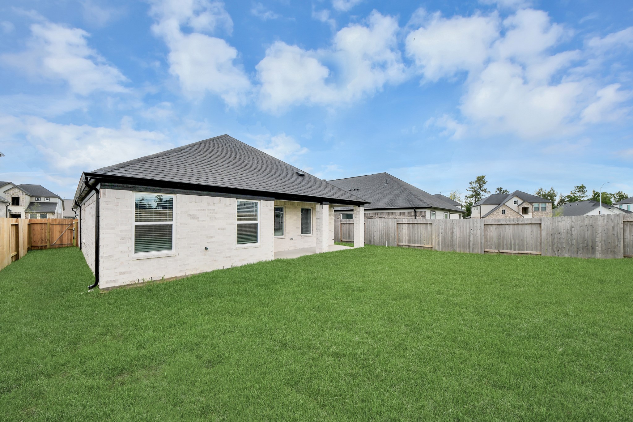 24507 Broad Park Spring, TX 77373 - Photo 9 of 37 Backyard retreat, offering an abundance of space for kids to play and explore. The possibilities are endless in this outdoor haven, where the joy of open-air activities and family gatherings awaits.