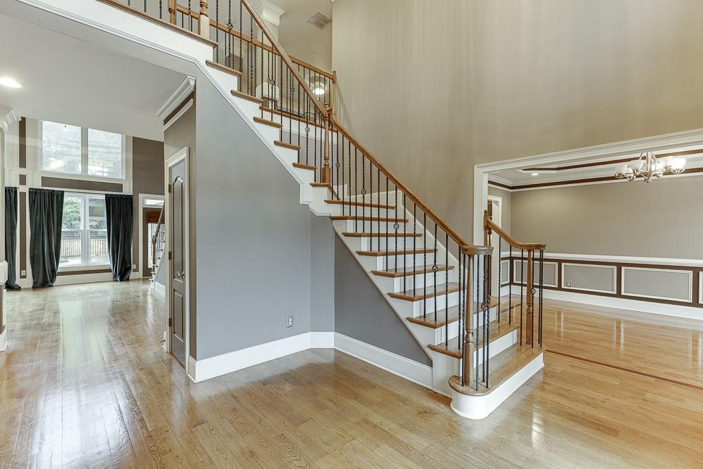 940 Chateau Forest Road Hoschton, GA 30548 - Photo 5 of 87 a view of staircase with white walls and windows