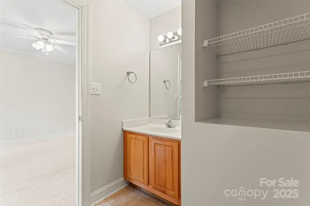 a bathroom with a granite countertop sink a mirror and shower