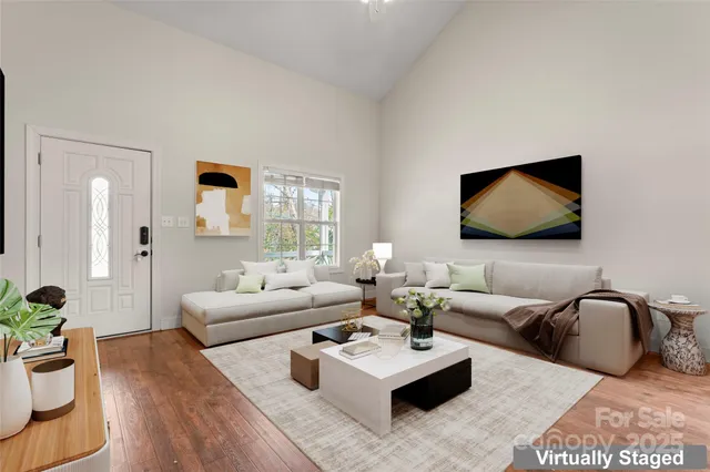 a living room with furniture a rug and a flat screen tv