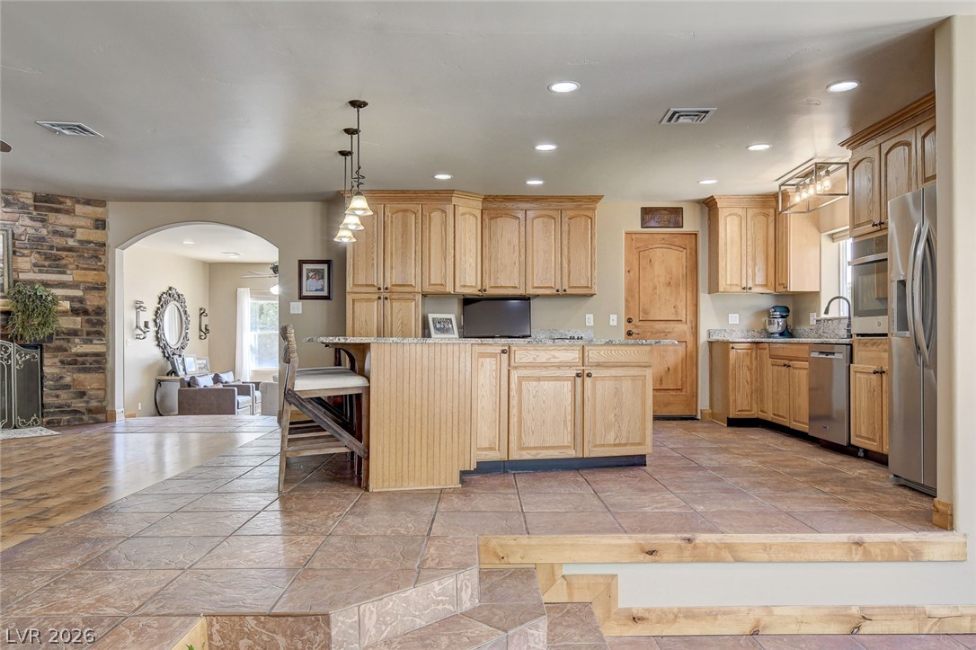 1950 Bowman Road Logandale, NV 89021 - Photo 21 of 81 A well-appointed kitchen featuring light oak wood cabinetry and stone countertops, perfect for entertaining.