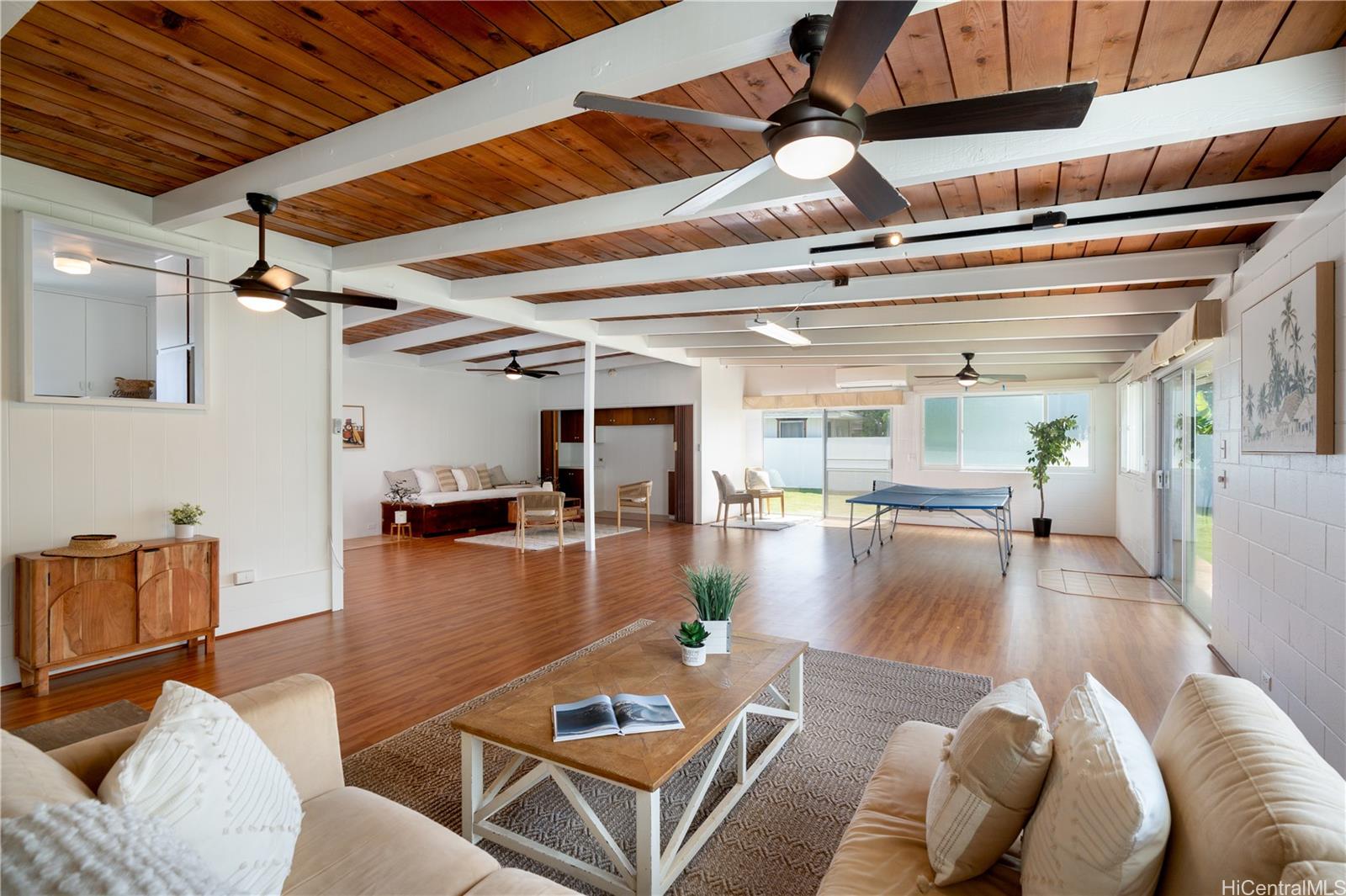 a living room with furniture and a floor to ceiling window