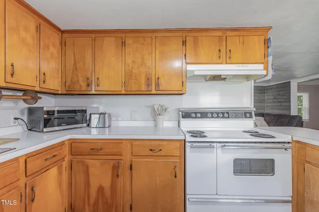 a kitchen with a table chairs and a refrigerator
