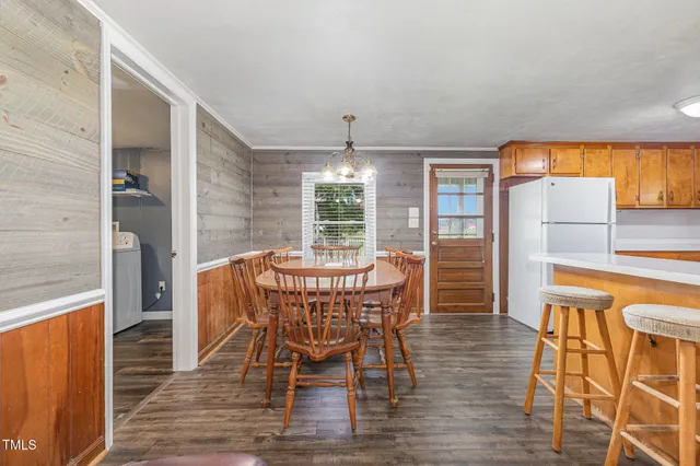 a dining table with chairs and window