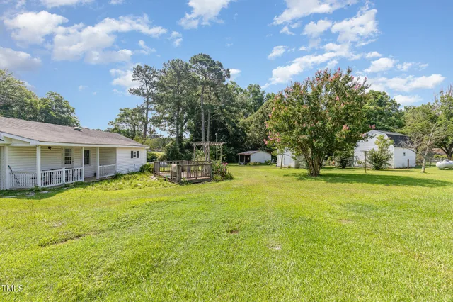 a view of a house with a yard and plants