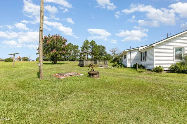 a view of a house with swimming pool and sitting area