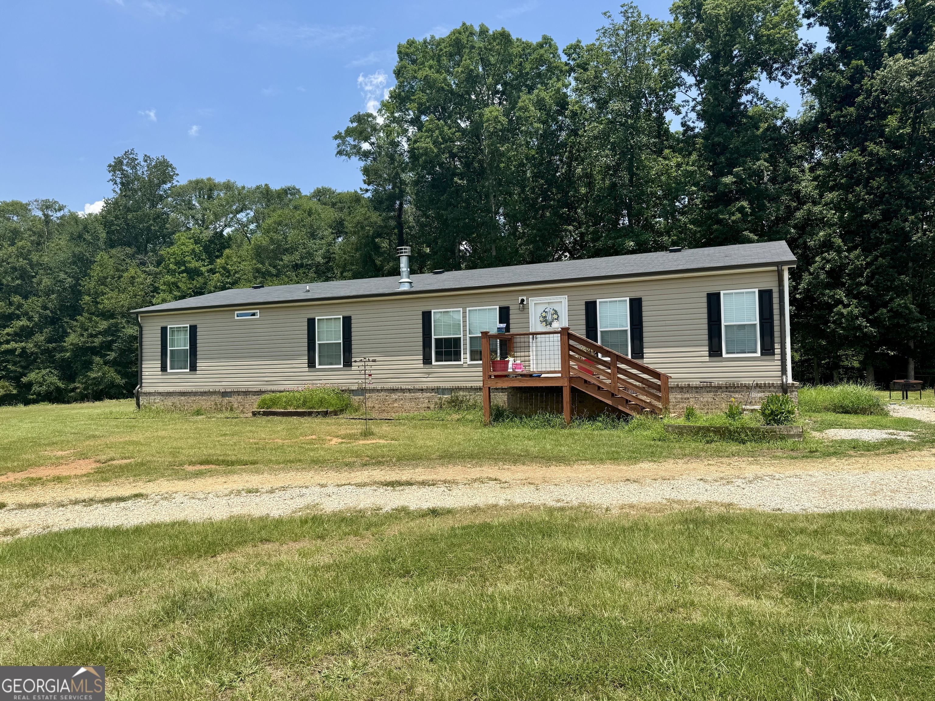 1148 Beaver Dam Road Hoschton, GA 30548 - Photo 6 of 11 a backyard of a house with barbeque oven and outdoor seating