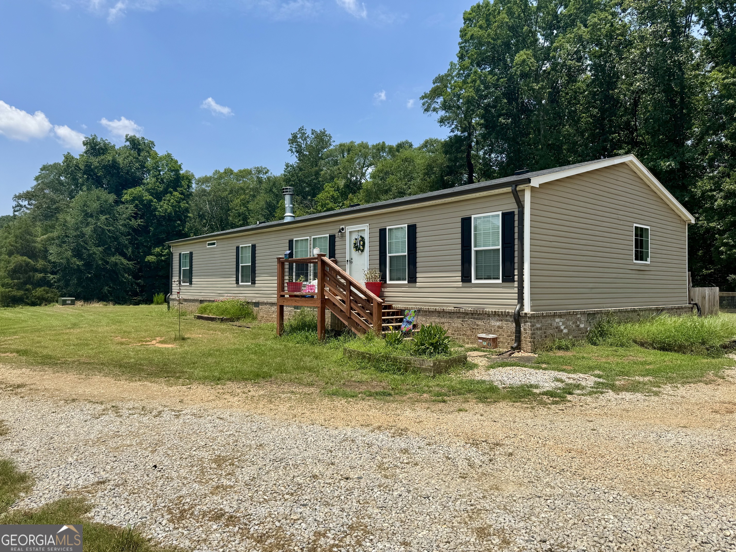 1148 Beaver Dam Road Hoschton, GA 30548 - Photo 7 of 11 a view of a house with backyard and garden