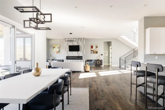 a view of a dining room with furniture and a chandelier