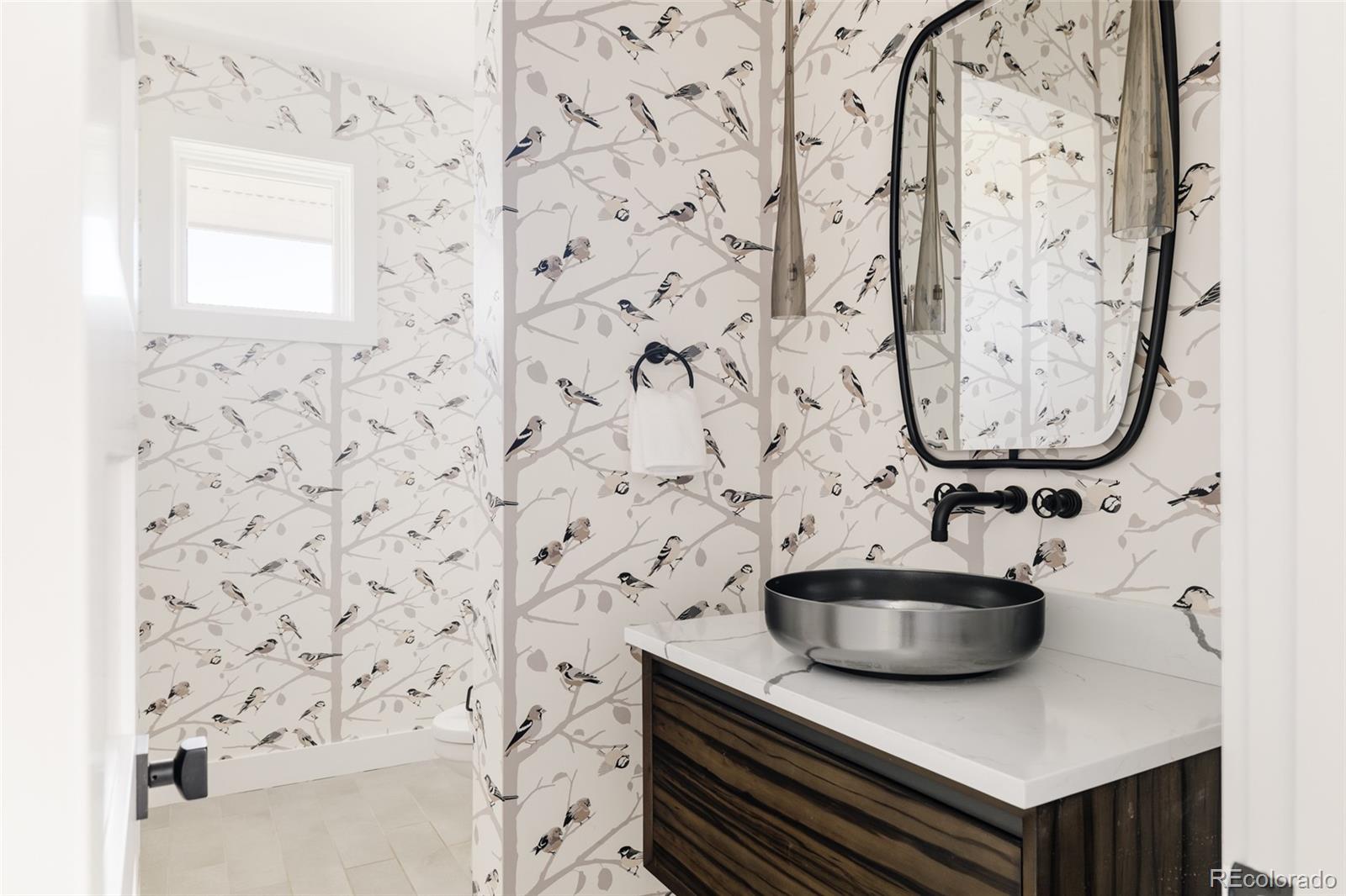 15480 Dinosaur Ridge Road Morrison, CO 80465 - Photo 19 of 50 a bathroom with a sink and a mirror