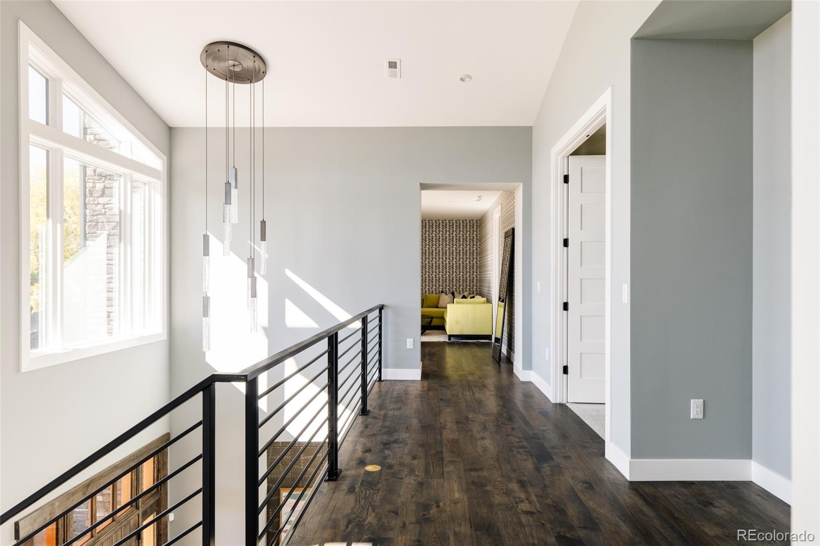 15480 Dinosaur Ridge Road Morrison, CO 80465 - Photo 22 of 50 a view of entryway with wooden floor and stairs