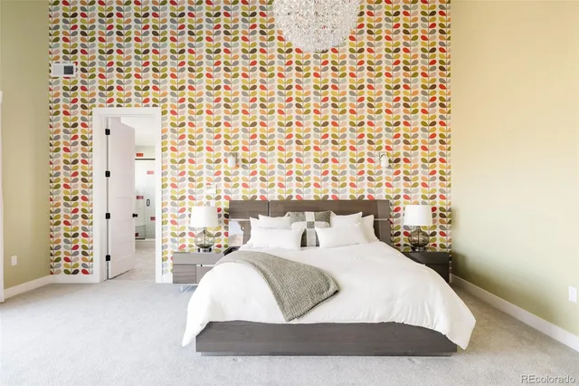 a large bed sitting in a bedroom next to a lamp