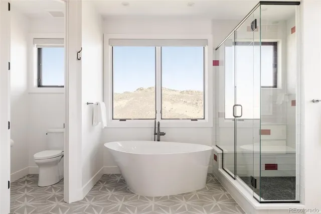 a bathroom with a bathtub and shower