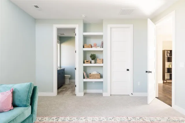 a living room with furniture and painting on the wall