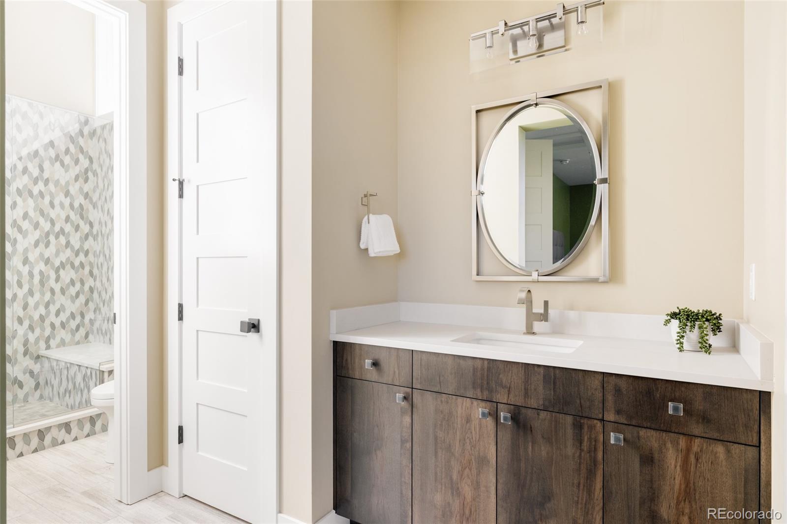 15480 Dinosaur Ridge Road Morrison, CO 80465 - Photo 38 of 50 a bathroom with a sink vanity and a mirror