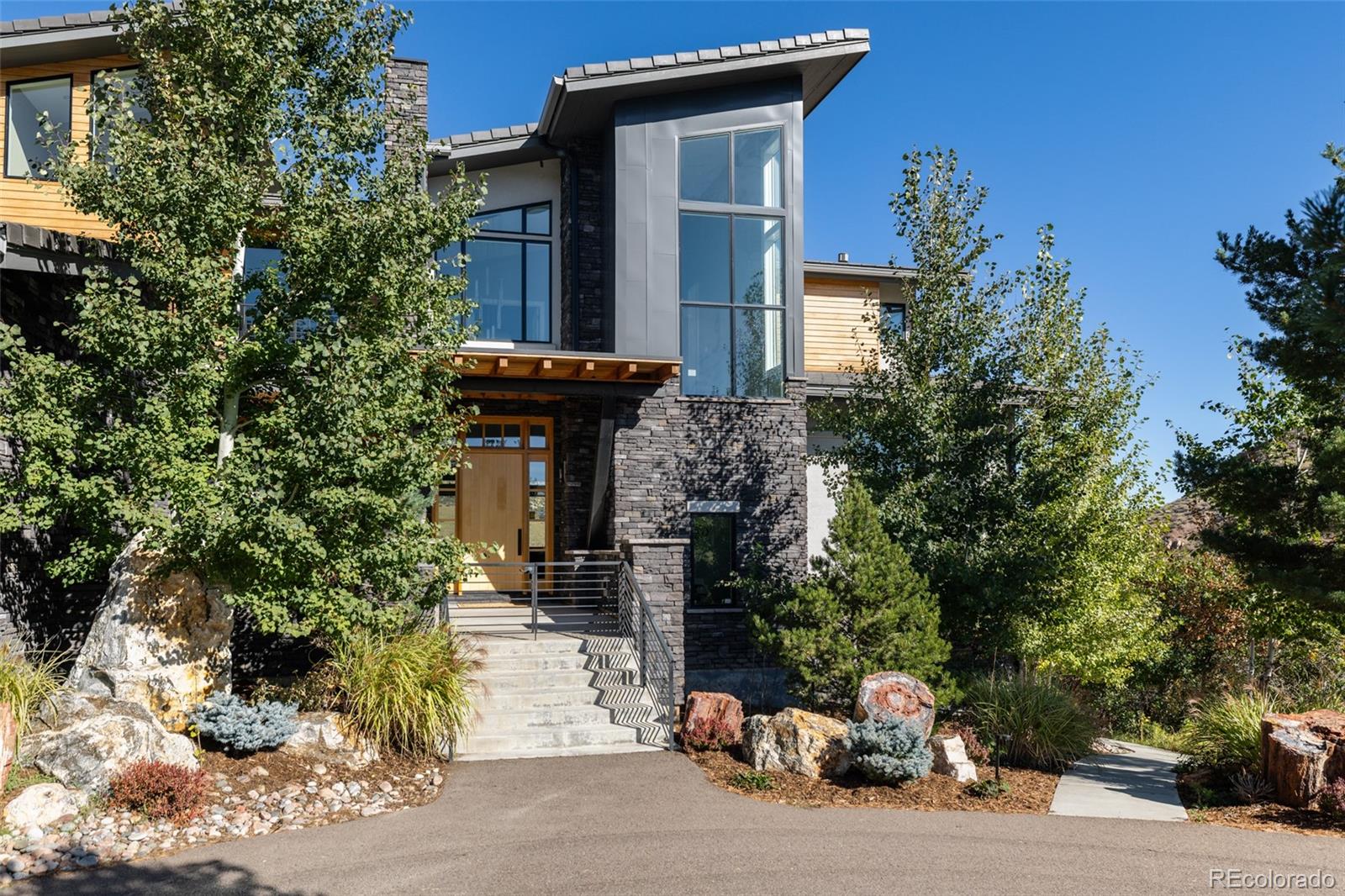 15480 Dinosaur Ridge Road Morrison, CO 80465 - Photo 4 of 50 a front view of a house with garden