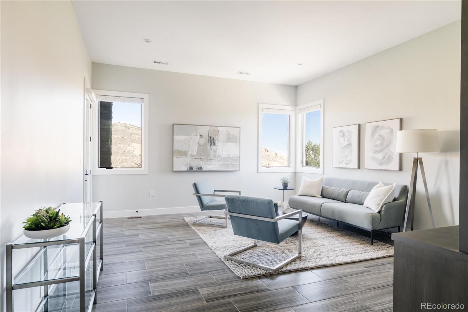 15480 Dinosaur Ridge Road Morrison, CO 80465 - Photo 44 of 50 a living room with furniture and wooden floor