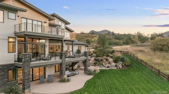 a view of a house with pool and chairs