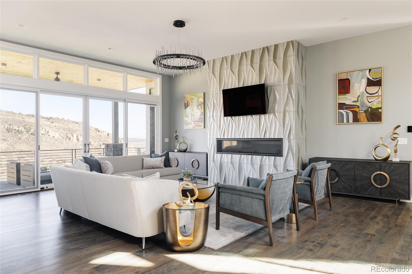 15480 Dinosaur Ridge Road Morrison, CO 80465 - Photo 6 of 50 a living room with furniture a flat screen tv and a floor to ceiling window