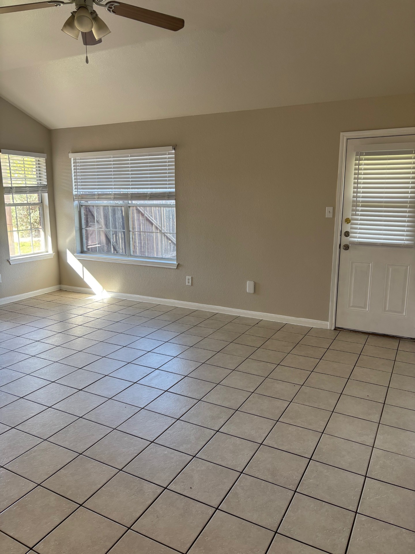 1410 Bergin Court, Unit B Georgetown, TX 78626 - Photo 3 of 13 an empty room with windows and cabinet