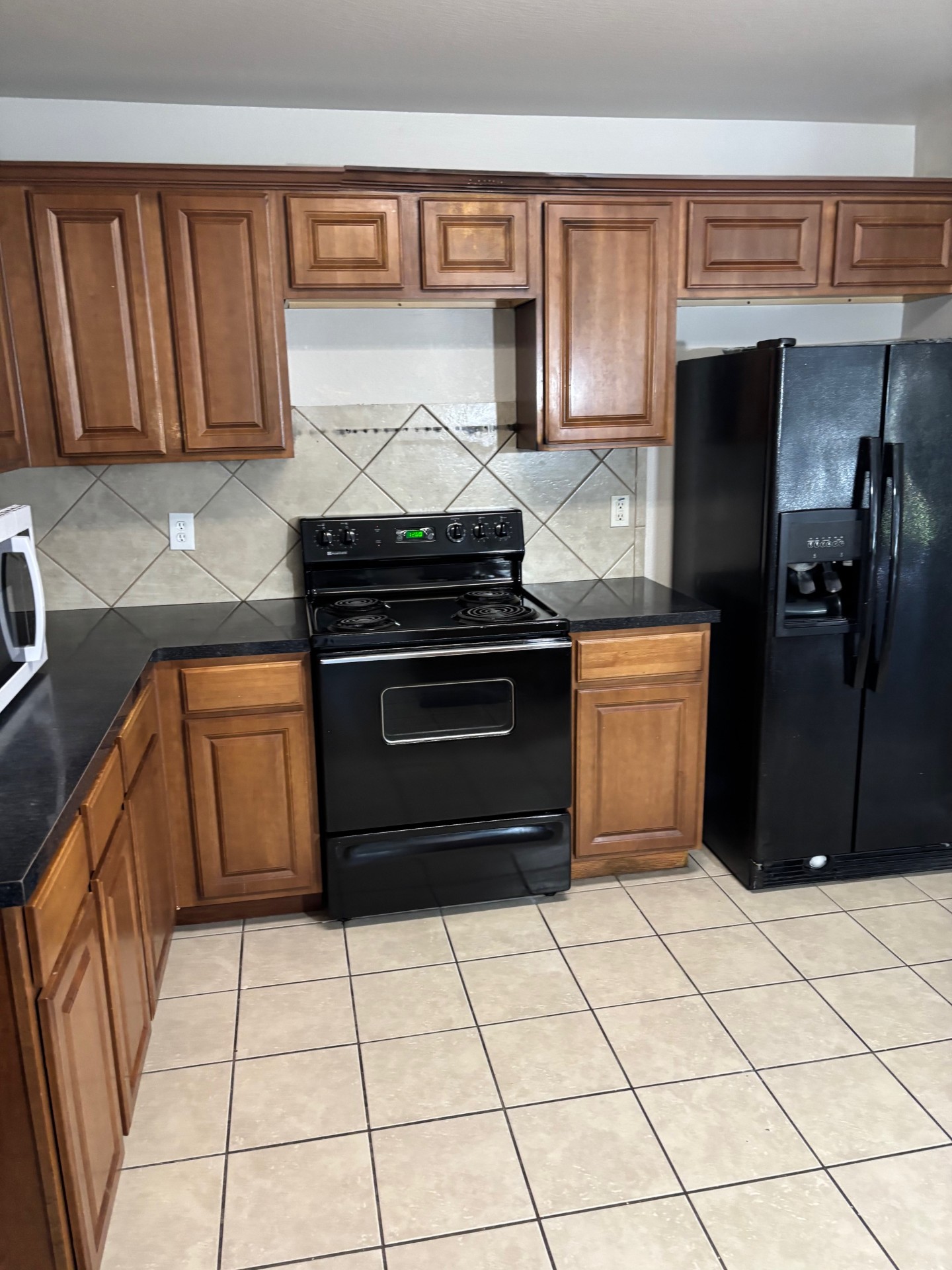 1410 Bergin Court, Unit B Georgetown, TX 78626 - Photo 6 of 13 a kitchen with a stove top oven cabinets and a refrigerator