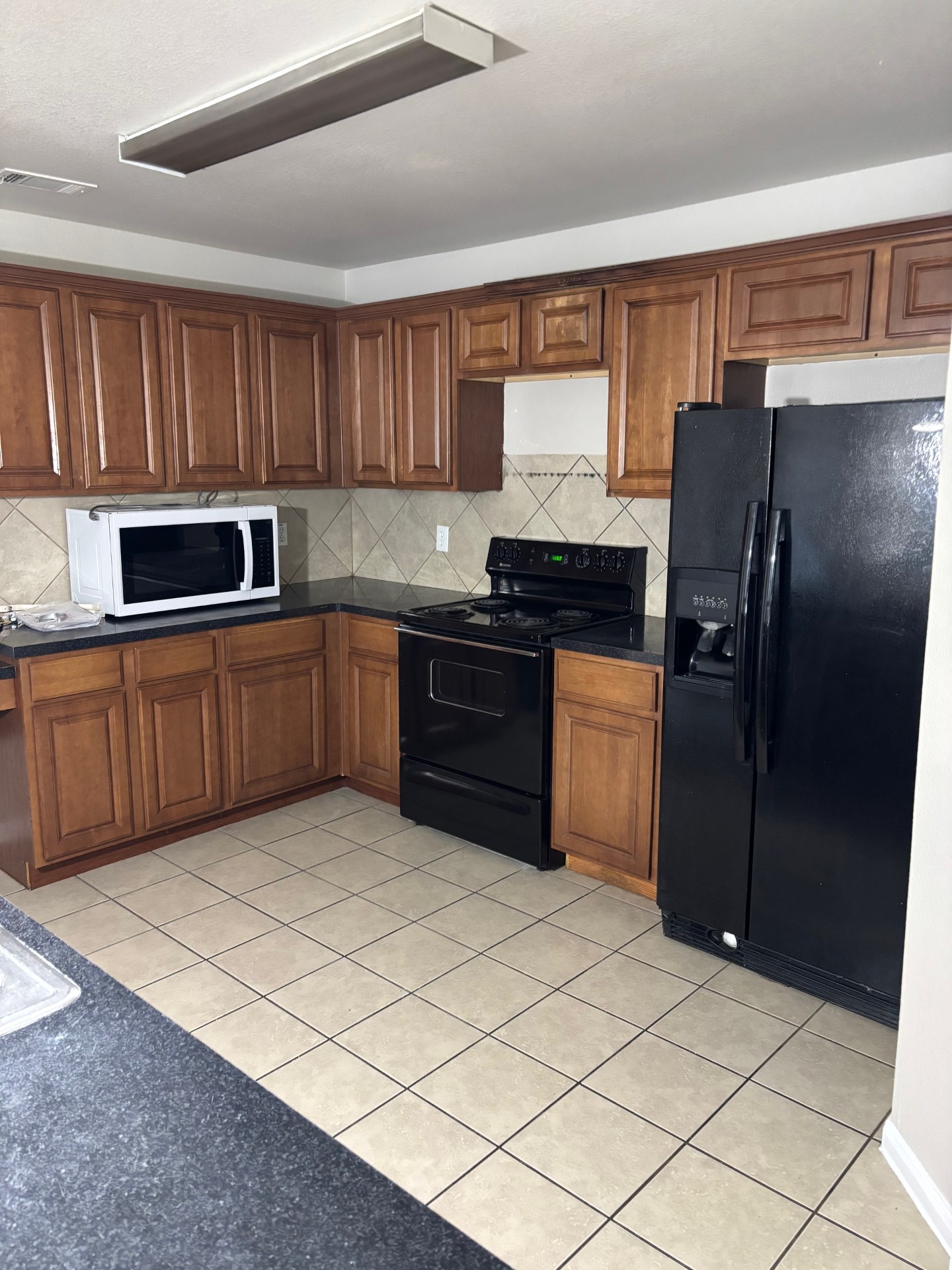 1410 Bergin Court, Unit B Georgetown, TX 78626 - Photo 7 of 13 a kitchen with stainless steel appliances granite countertop a refrigerator and a stove top oven