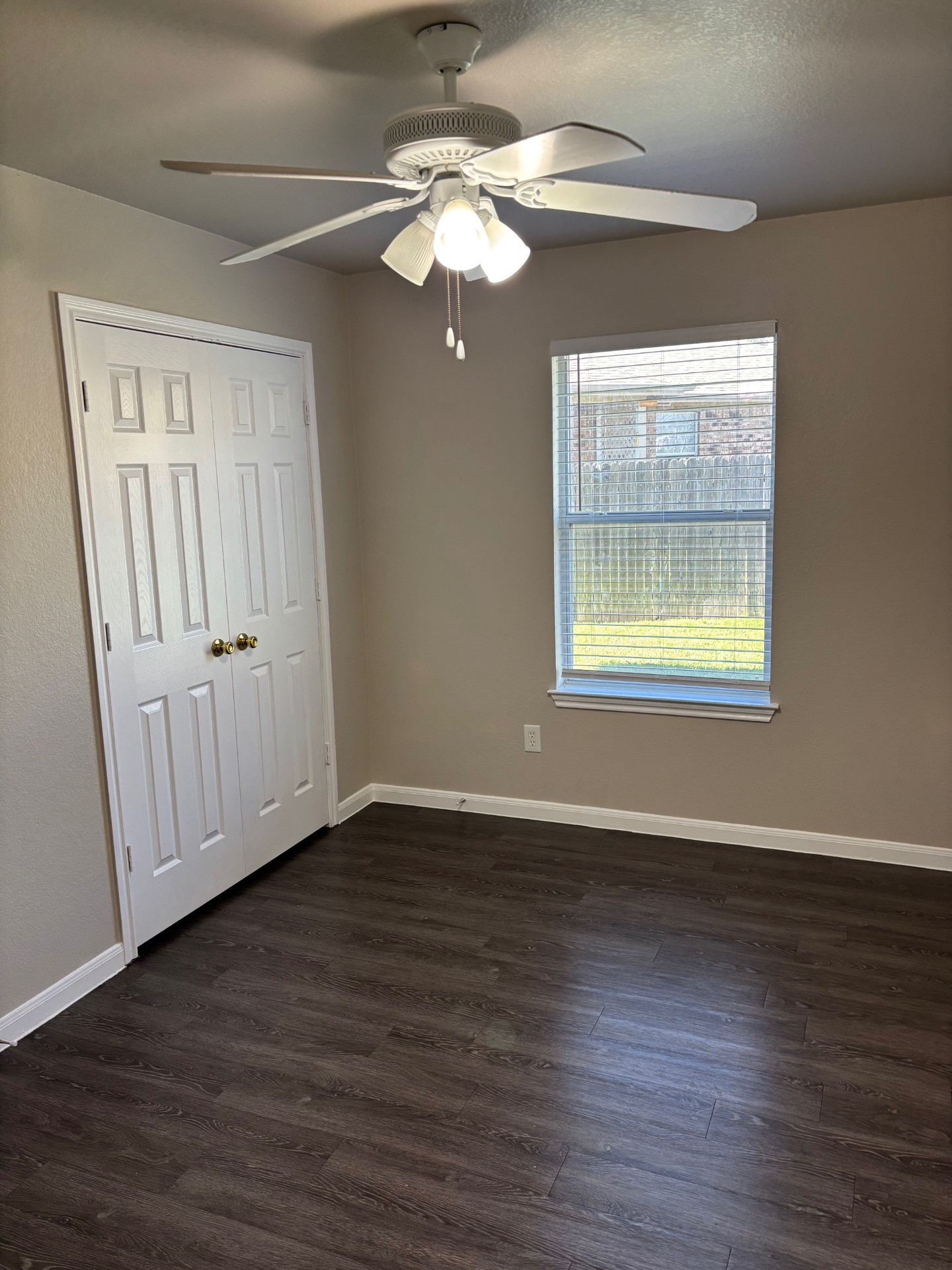 1410 Bergin Court, Unit B Georgetown, TX 78626 - Photo 8 of 13 an empty room with wooden floor chandelier fan and windows