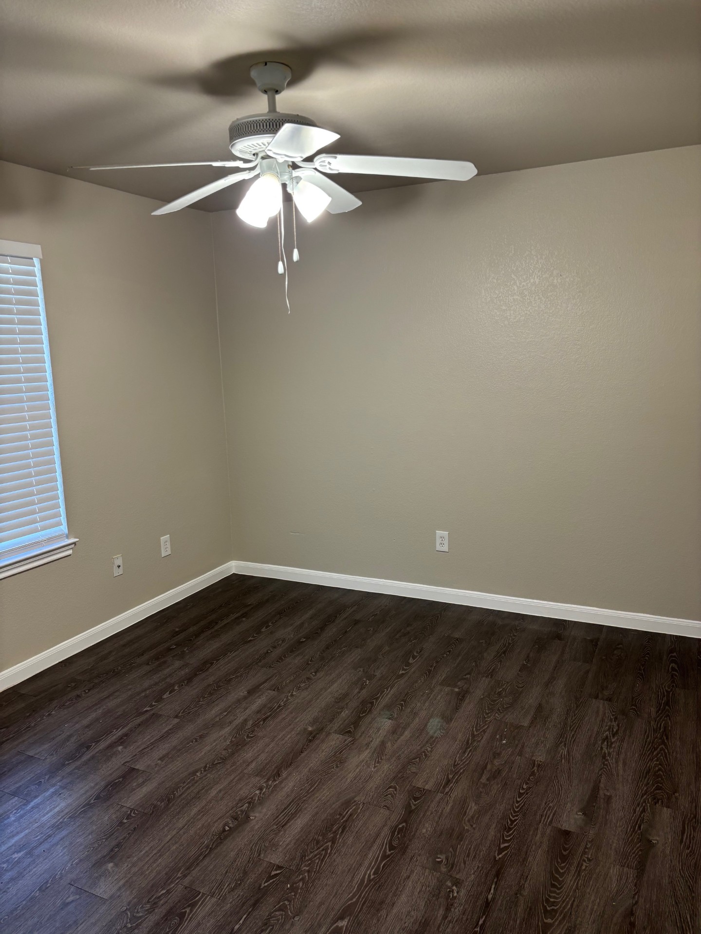 1410 Bergin Court, Unit B Georgetown, TX 78626 - Photo 9 of 13 a view of an empty room with wooden floor and a window