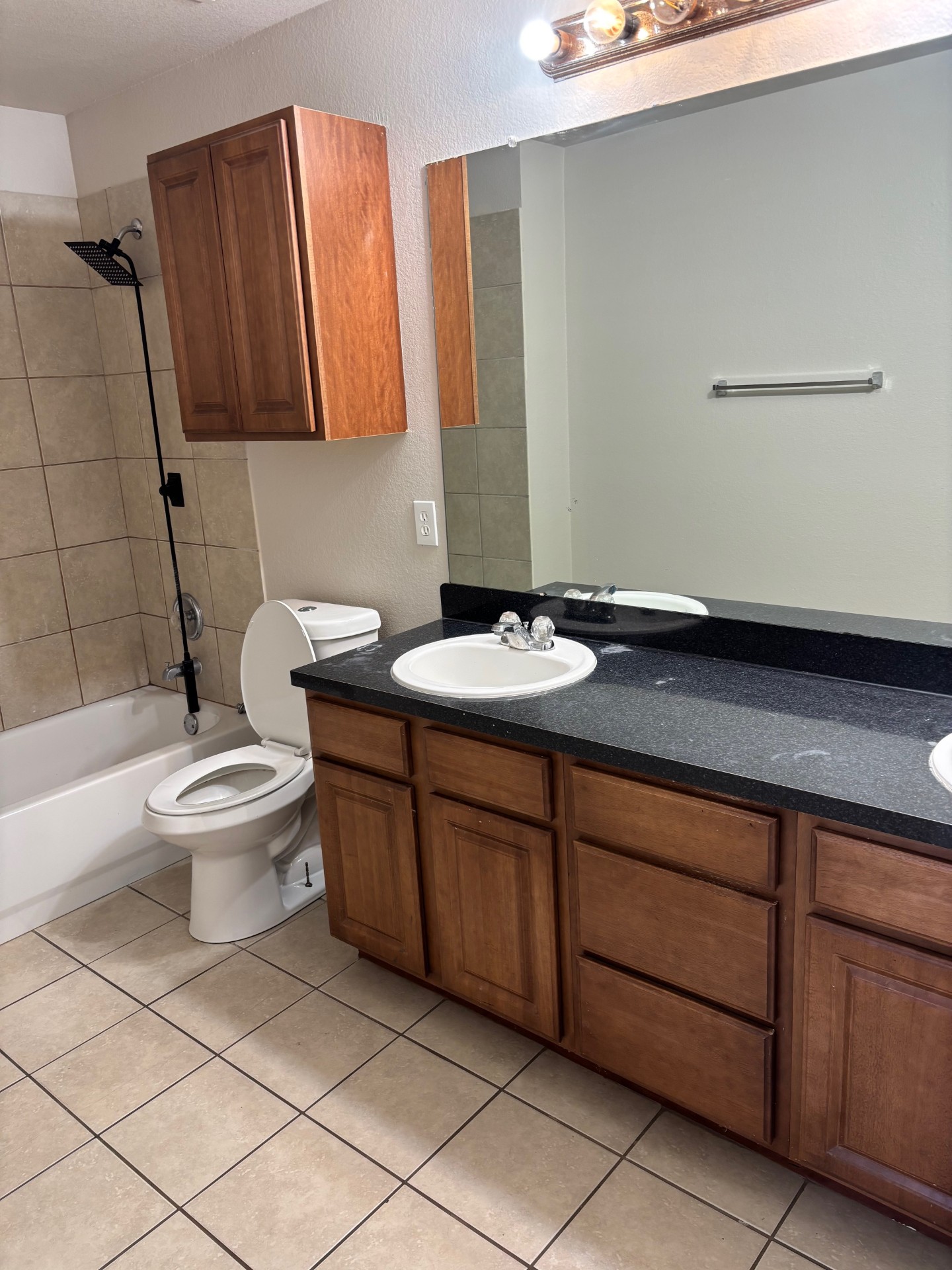 1410 Bergin Court, Unit B Georgetown, TX 78626 - Photo 10 of 13 a bathroom with a granite countertop sink a toilet and a mirror