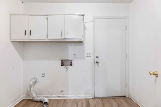 a view of an empty room with a fireplace and a window