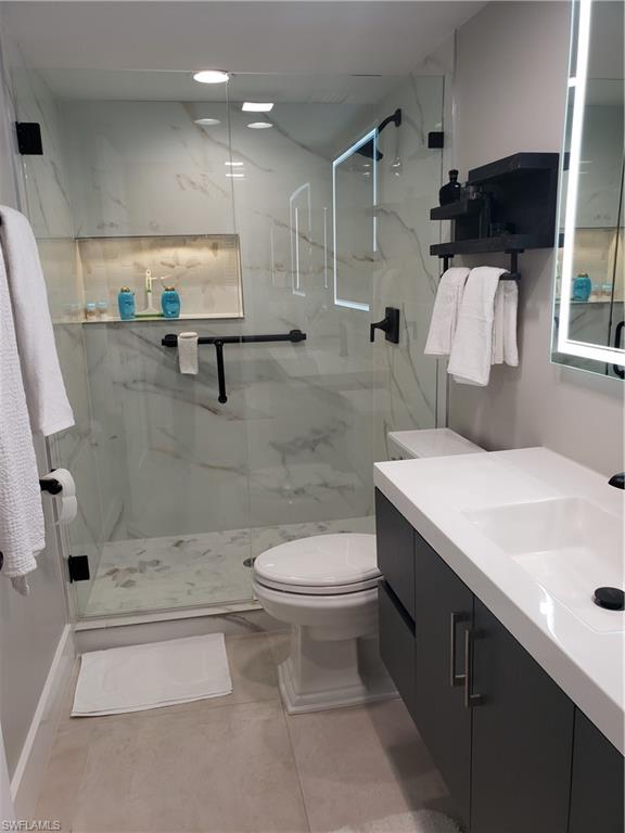 5435 Rattlesnake Hammock Road, Unit E102 Naples, FL 34113 - Photo 11 of 32 a bathroom with a sink toilet and shower