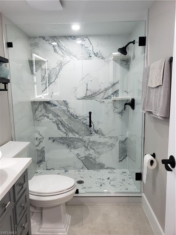 5435 Rattlesnake Hammock Road, Unit E102 Naples, FL 34113 - Photo 18 of 32 a bathroom with a sink toilet and shower