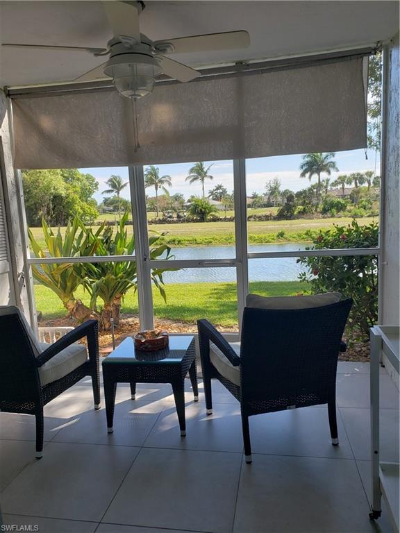 5435 Rattlesnake Hammock Road, Unit E102 Naples, FL 34113 - Photo 23 of 32 a room with furniture and a floor to ceiling window