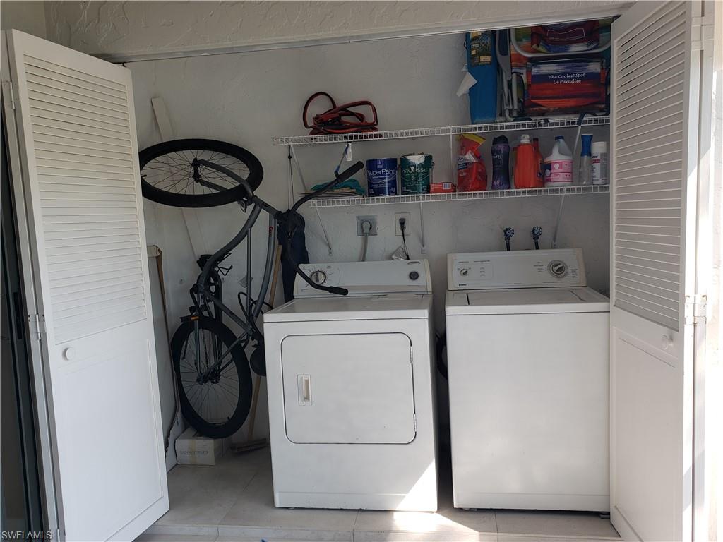 5435 Rattlesnake Hammock Road, Unit E102 Naples, FL 34113 - Photo 24 of 32 a utility room with dryer and washer