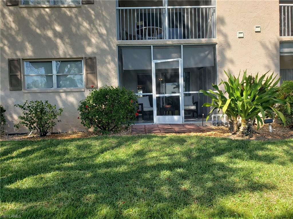 5435 Rattlesnake Hammock Road, Unit E102 Naples, FL 34113 - Photo 28 of 32 a view of house with yard and potted plants