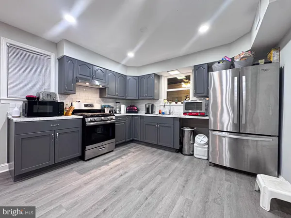 a kitchen with a refrigerator a sink and cabinets