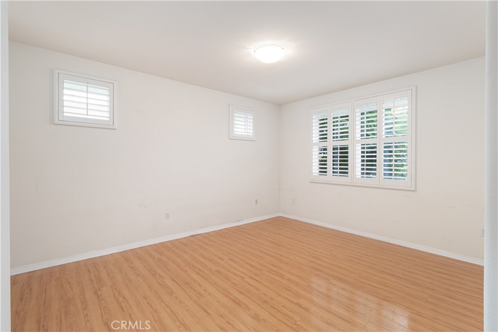755 Francesca Drive, Unit 201 Walnut, CA 91789 - Photo 13 of 28 a view of an empty room with wooden floor and a window