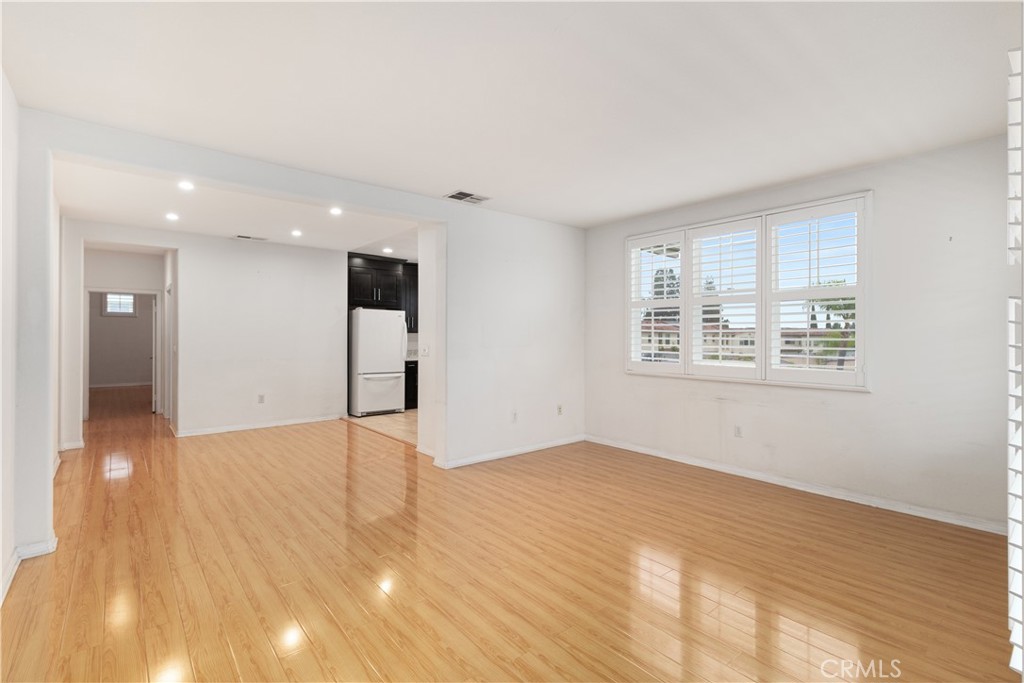 755 Francesca Drive, Unit 201 Walnut, CA 91789 - Photo 3 of 28 an empty room with wooden floor and windows