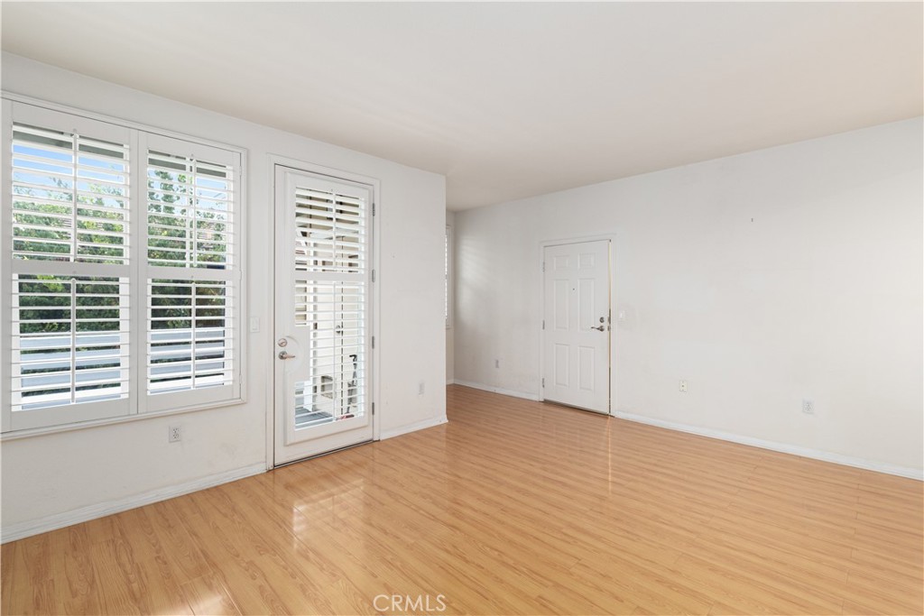 755 Francesca Drive, Unit 201 Walnut, CA 91789 - Photo 5 of 28 a view of an empty room with wooden floor and a window