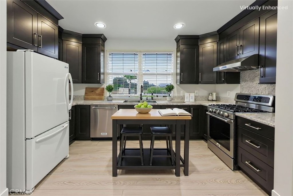 755 Francesca Drive, Unit 201 Walnut, CA 91789 - Photo 9 of 28 a kitchen with stainless steel appliances granite countertop a sink a stove a refrigerator and island with wooden floor