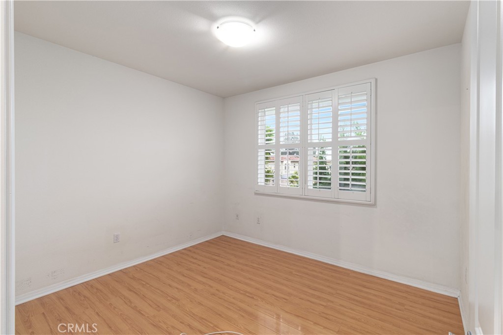 755 Francesca Drive, Unit 201 Walnut, CA 91789 - Photo 10 of 28 an empty room with wooden floor and windows