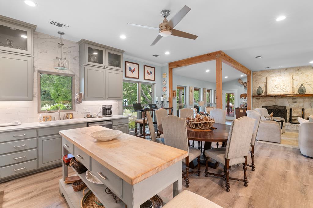 290 Cardinal Hill Road Ingram, TX 78025 - Photo 13 of 57 a large kitchen with a table and chairs