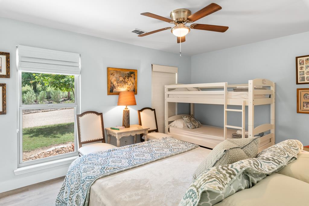 290 Cardinal Hill Road Ingram, TX 78025 - Photo 19 of 57 a bedroom with a large bed and a window