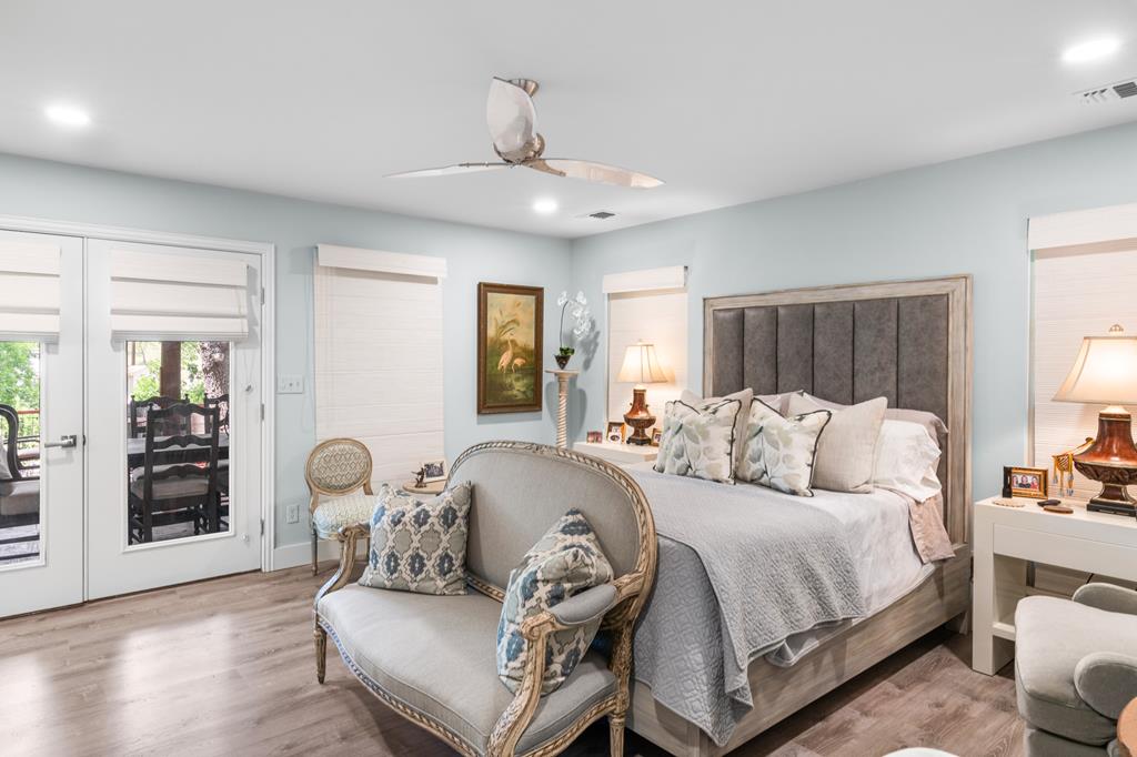 290 Cardinal Hill Road Ingram, TX 78025 - Photo 20 of 57 a spacious bedroom with a bed and wooden floor