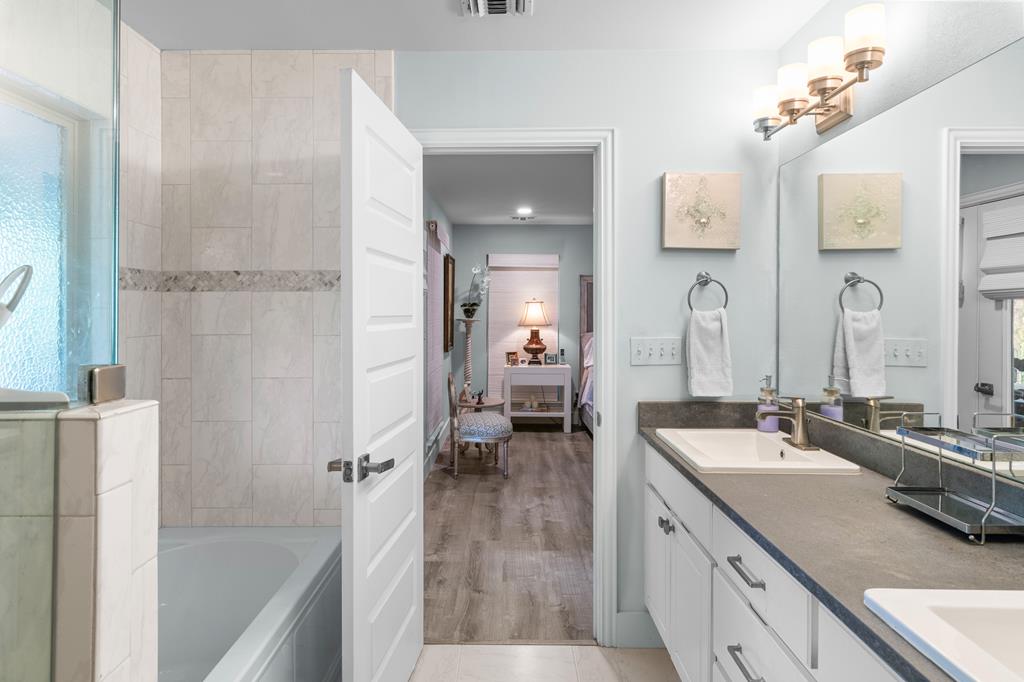 290 Cardinal Hill Road Ingram, TX 78025 - Photo 23 of 57 a en suite bathroom with a double vanity sink a mirror and a shower
